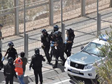 Varios agentes trasladan a un inmigrante en Ceuta Varios agentes trasladan a un inmigrante en Ceuta