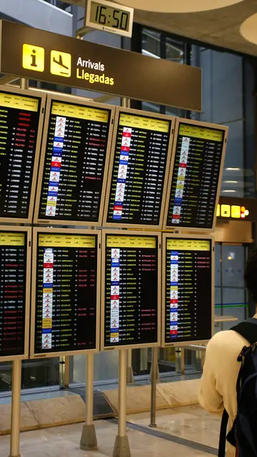 Un pasajero consulta la lista de vuelos en Barajas Un pasajero consulta la lista de vuelos en Barajas