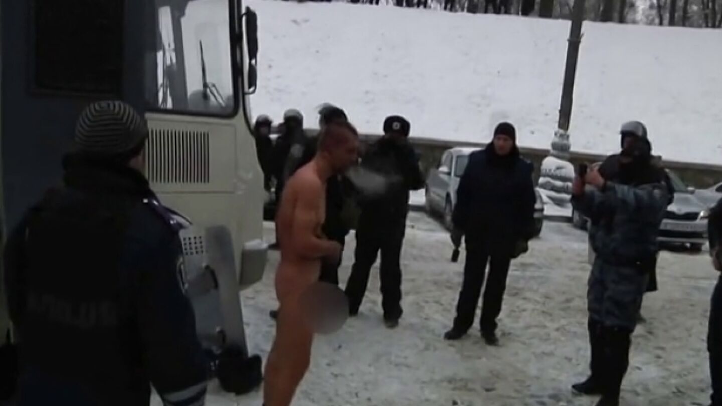 La polic&iacute;a de Kiev obliga a un detenido a permanecer desnudo bajo la nieve