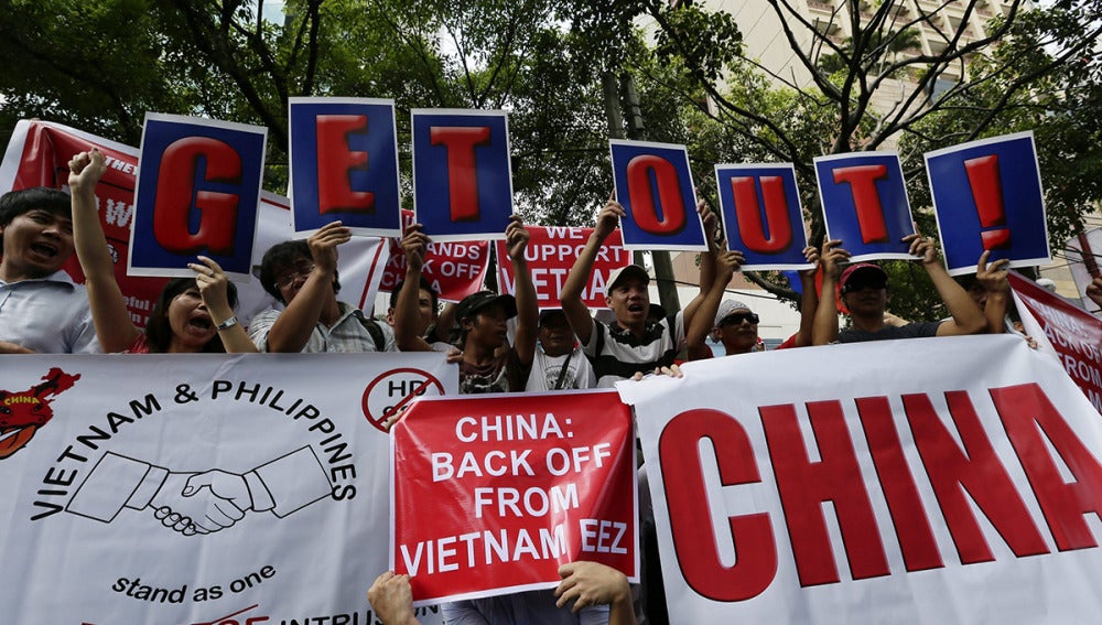 Activistas filipinos ondean banderas durante una manifestación contra China