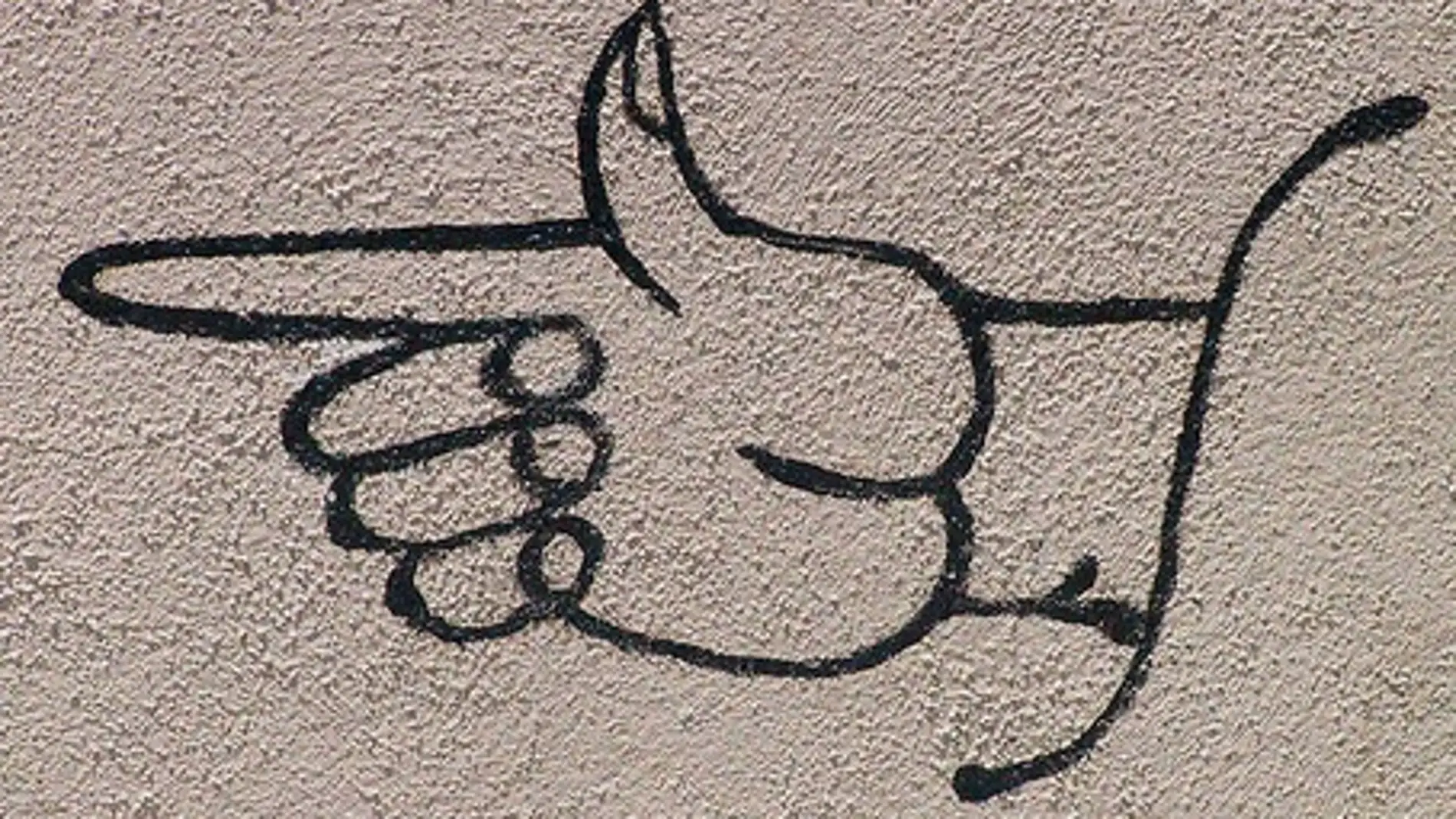 Graffiti de una mano señalando con el dedo índice