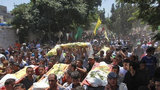 Amigos y familiares palestinos de la familia Kawarea transportan varios cadáveres Amigos y familiares palestinos de la familia Kawarea transportan varios cadáveres