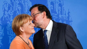 Mariano Rajoy da un beso en la mejilla a Angela Merkel