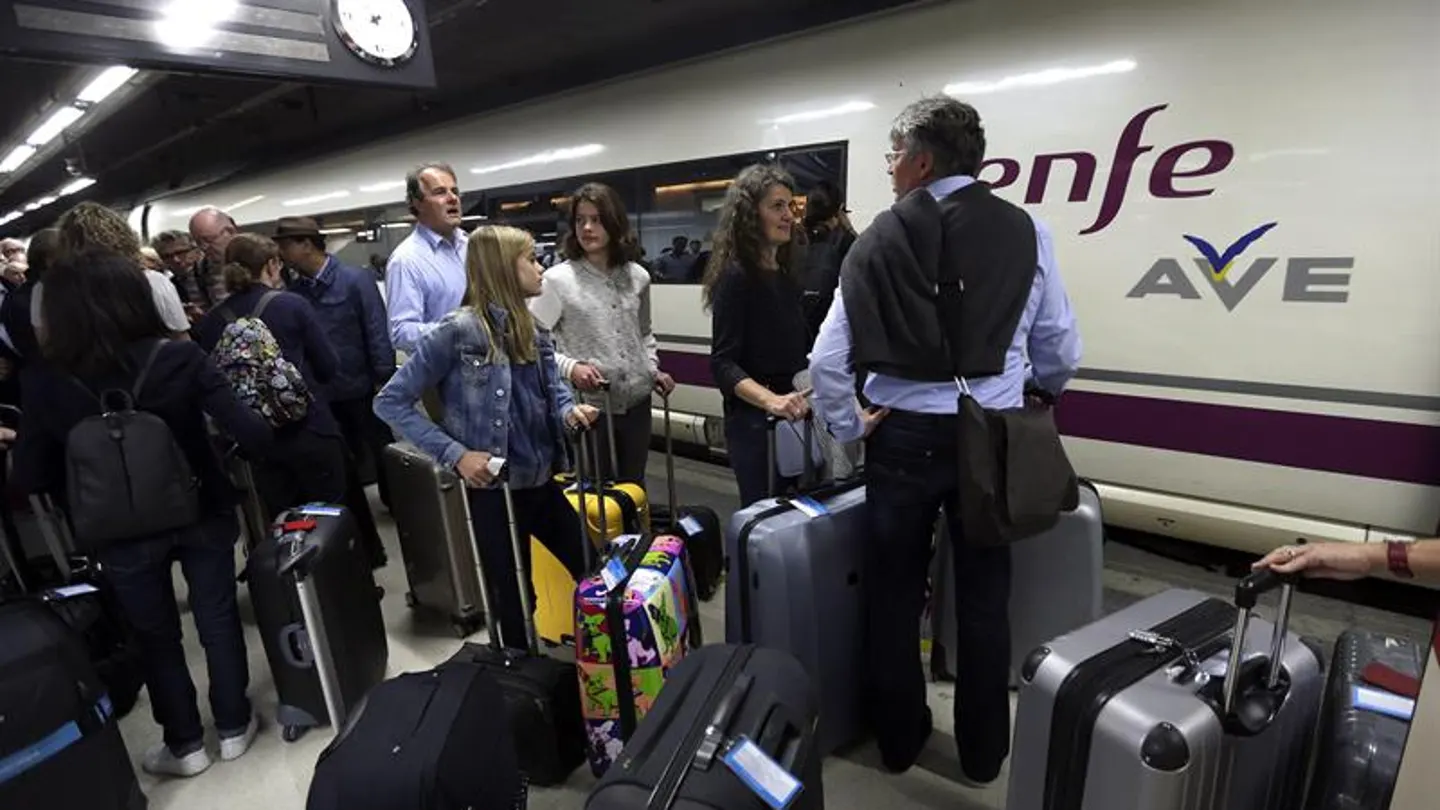 Pasajeros esperando subir a un tren AVE Pasajeros esperando subir a un tren AVE