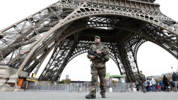 Un militar bajo la torre Eiffel, en París