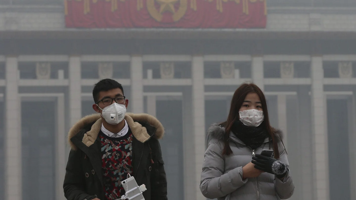 Ciudadanos chinos con mascarilla por la contaminación Ciudadanos chinos con mascarilla por la contaminación