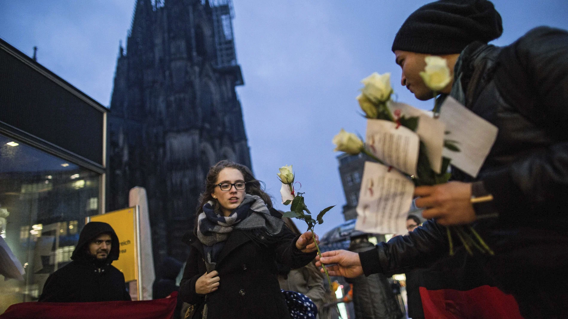 Mujeres dejan flores en la estación de Colonia