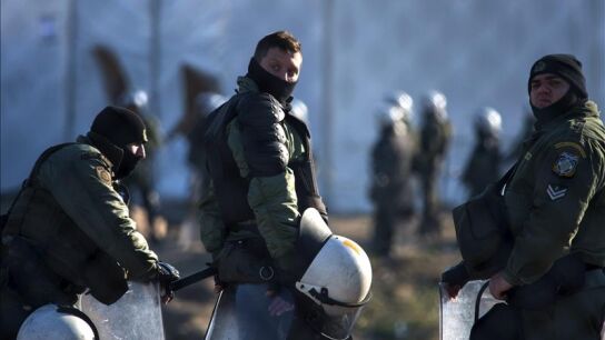 Un grupo polic&iacute;as griegos en un campamento cerca de Idomeni, en Grecia