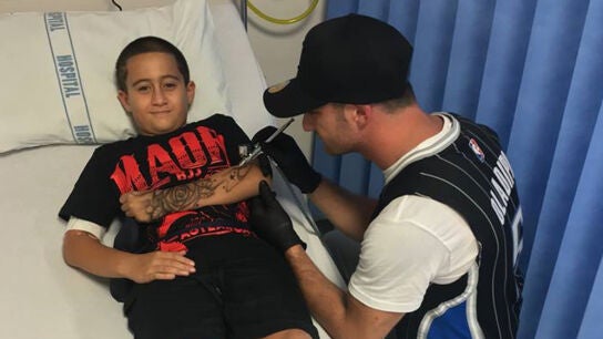 Imagen del tatuador australiano, con uno de los ni&ntilde;os