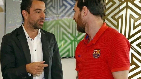 Xavi habla con Messi en la visita al Barça