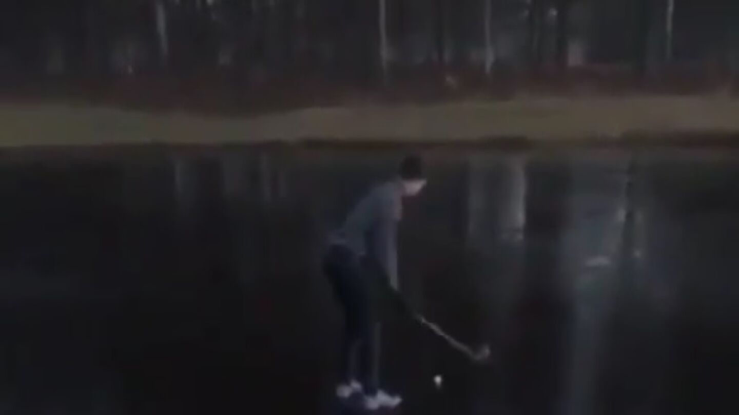 Intenta sacar una pelota de golf de un lago helado 