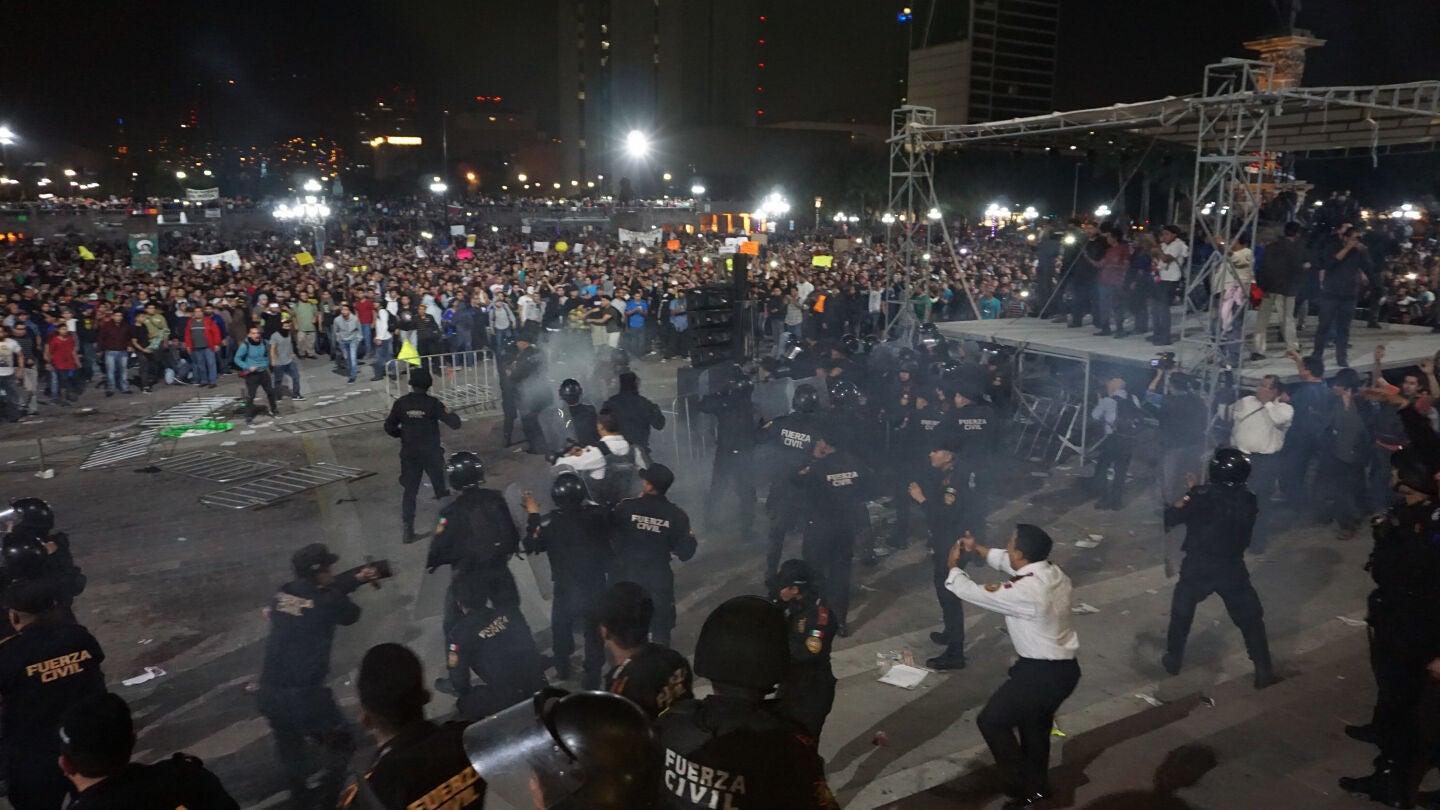 Polic&iacute;as de la ciudad de Monterrey (M&eacute;xico) se enfrentan con un tumulto de manifestantes