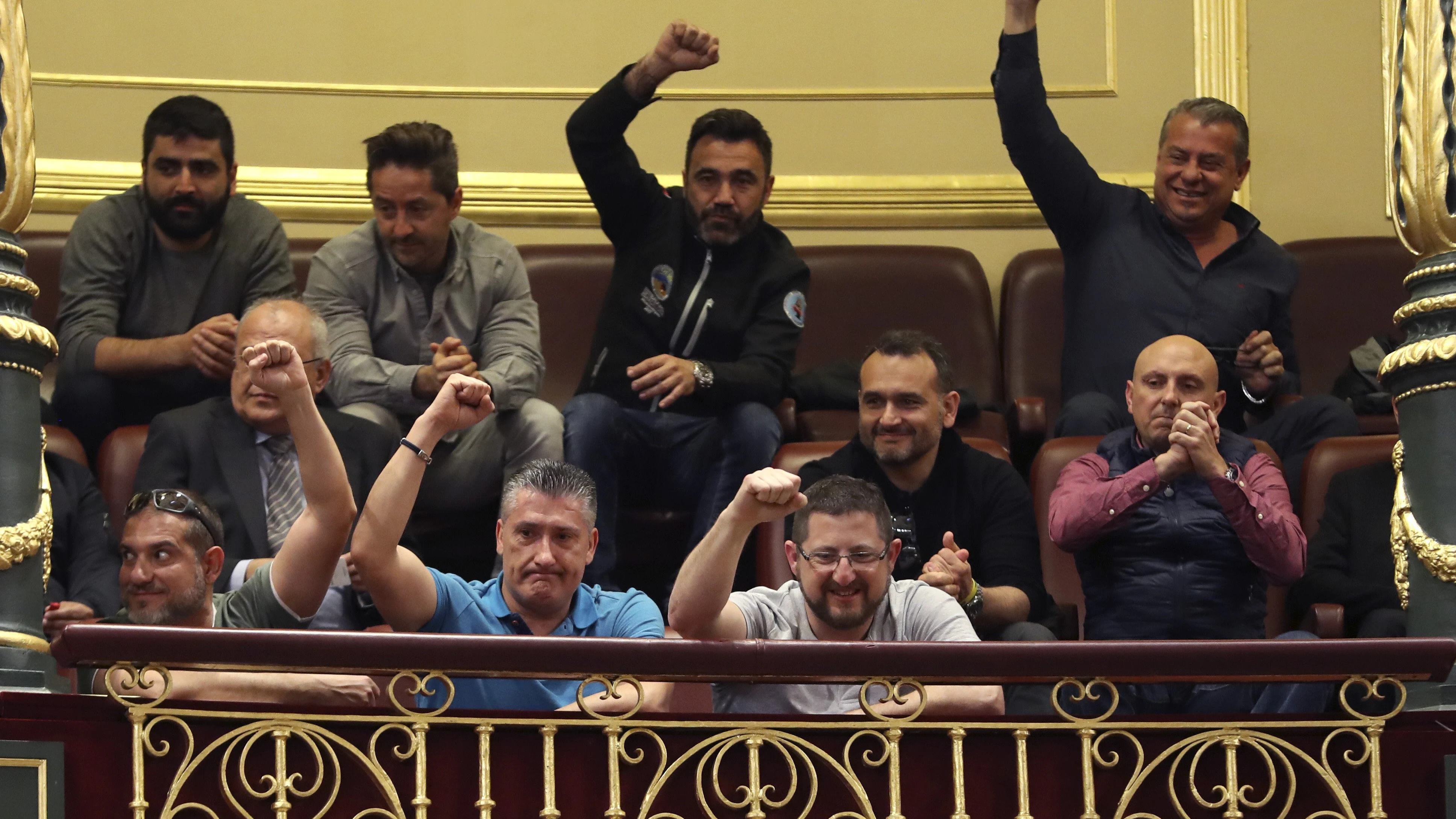 Un grupo de estibadores saludan desde la tribuna de invitados del Congreso 