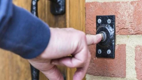 Imagen de archivo de una señor llamando a un timbre Imagen de archivo de una señor llamando a un timbre