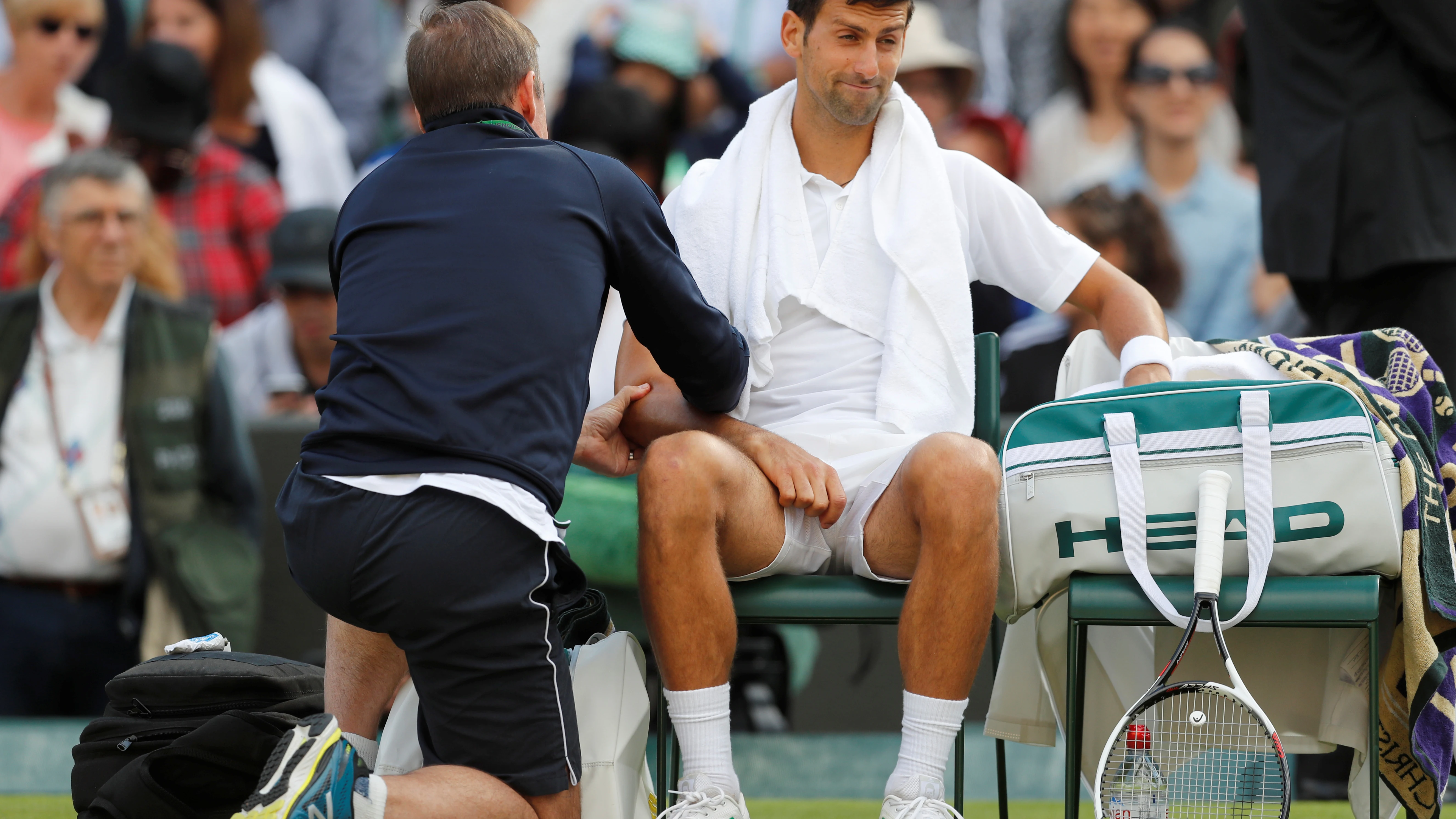 Novak Djokovic, atendido por un fisioterapeuta en Wimbledon