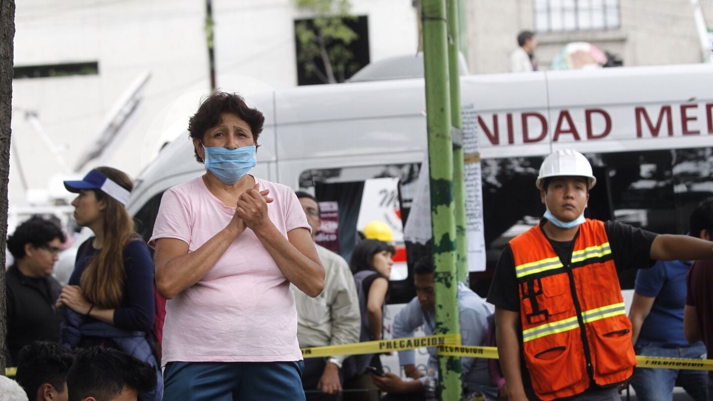 Una mujer espera noticias de sus familaires durante las operaciones de b&uacute;squeda de posibles supervivientes