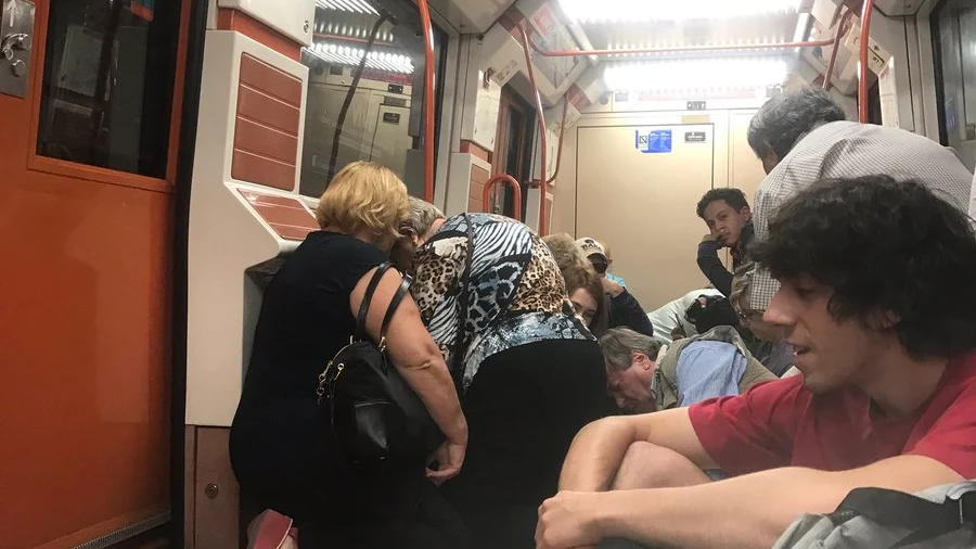 Los pasajeros se agachan dentro del vagón de metro