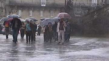 Gente paseando en Santiago de Compostela lloviendo