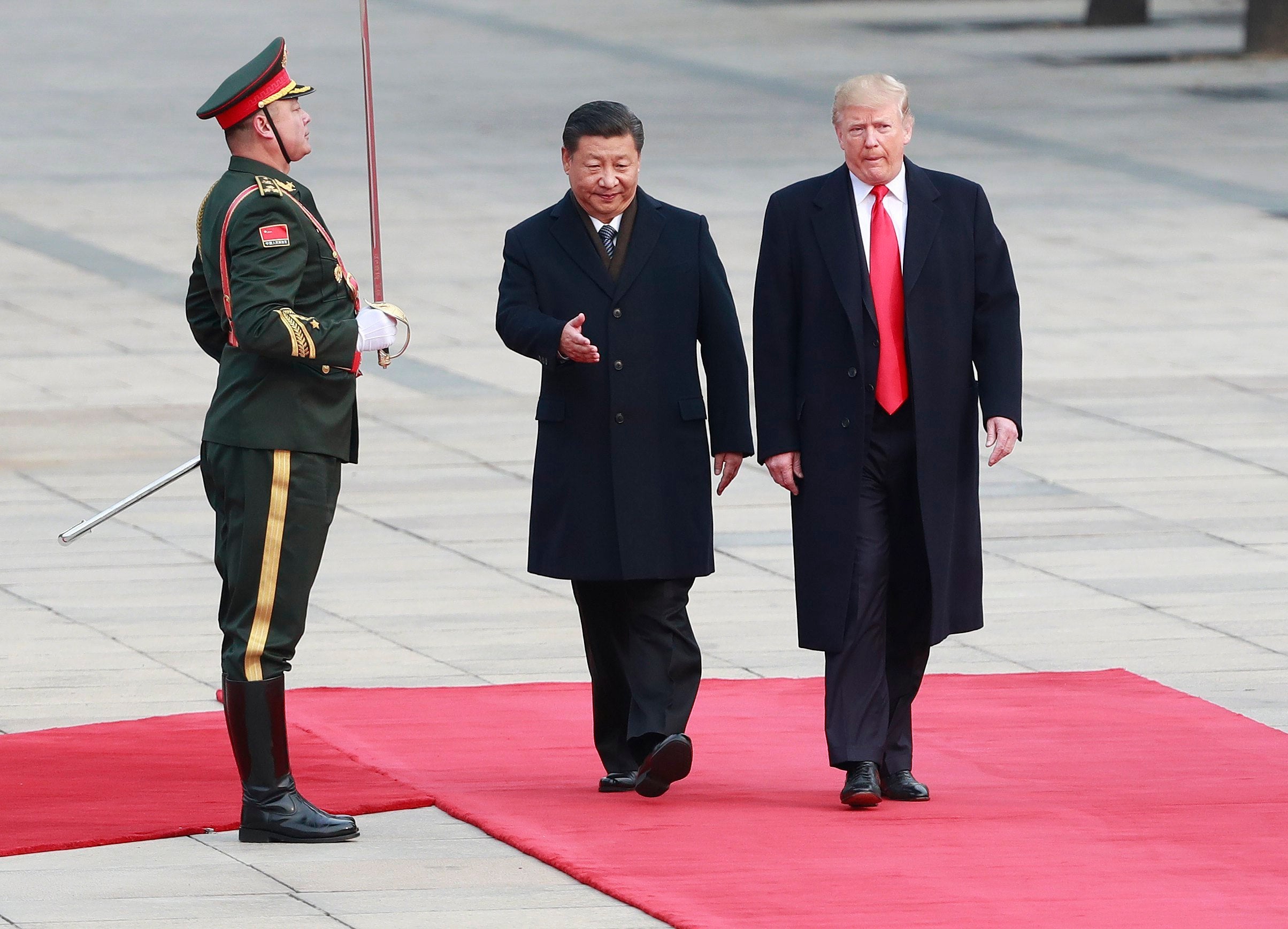 El presidente estadounidense Donald Trump (d) es recibido por su homólogo de China Xi Jinping (c) 