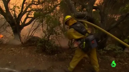 Un bombero intenta apagar un fuego Un bombero intenta apagar un fuego