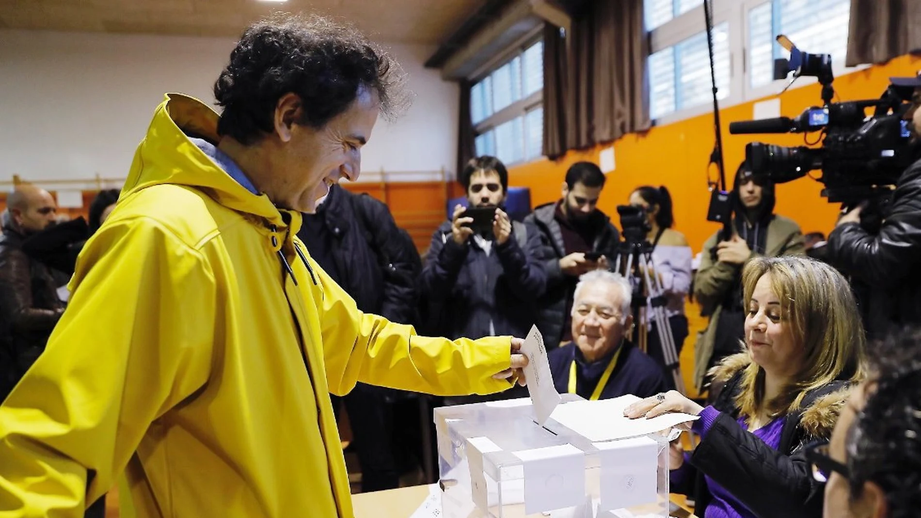 Un votante con un chubasquero amarillo