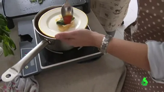 Una cocinera elabora una de las tapas Una cocinera elabora una de las tapas