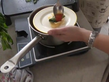 Una cocinera elabora una de las tapas Una cocinera elabora una de las tapas