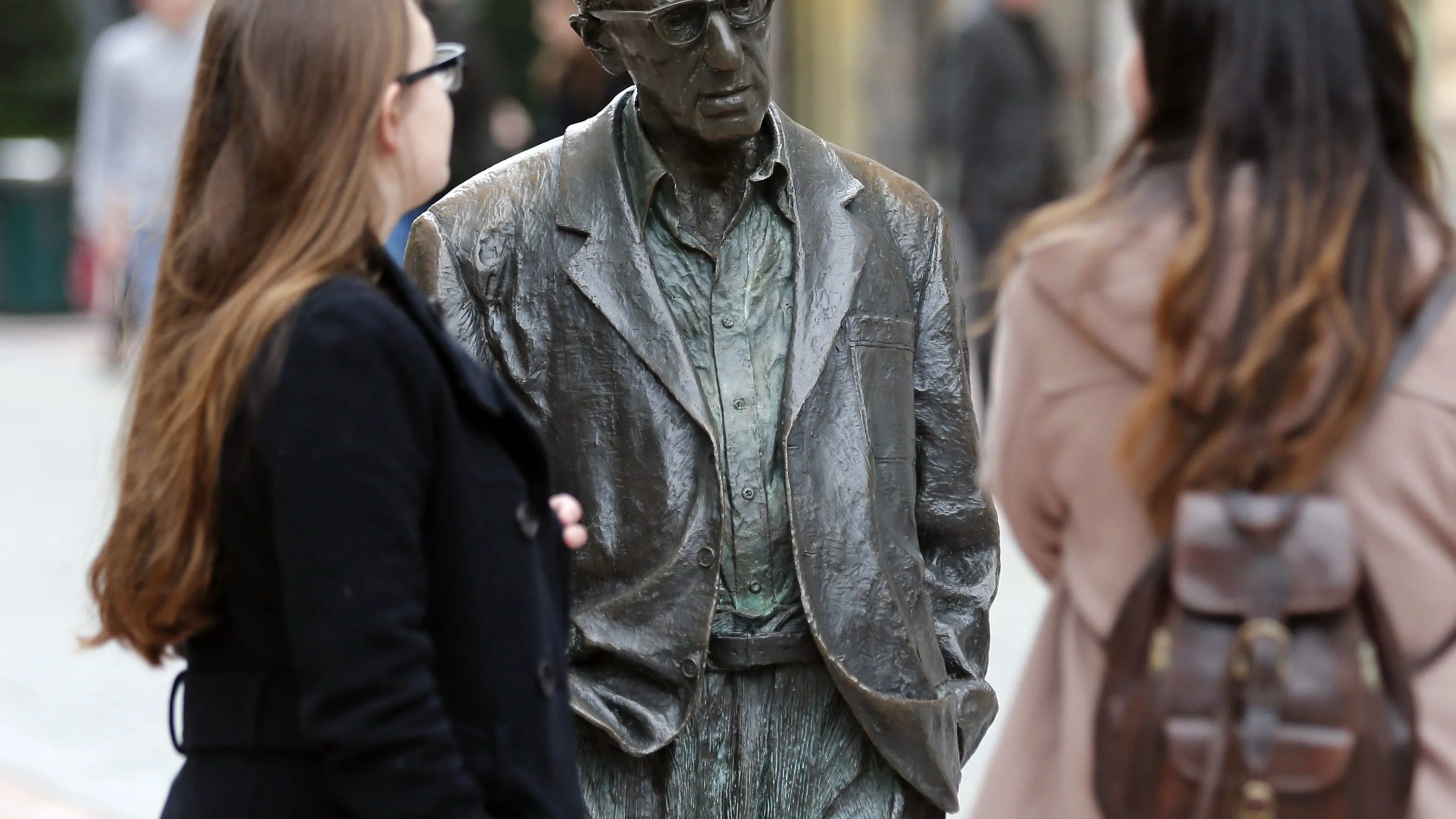 Turistas junto a la estatua de Woody Allen en Oviedo