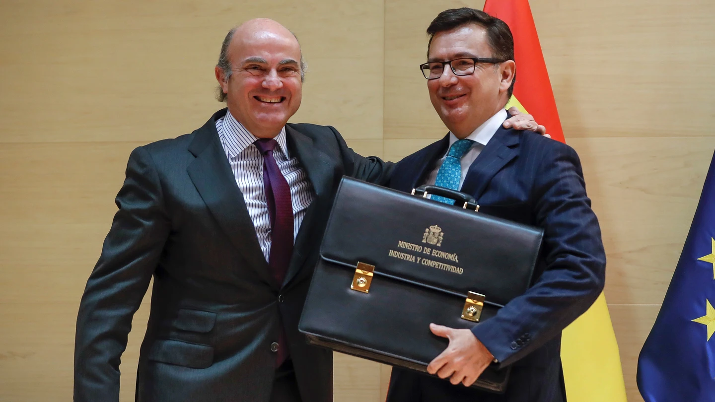 El ministro de Economía, Industria y Competitividad, Román Escolano, toma posesión de su cargo en un acto en el que su antecesor, Luis de Guindos, le traspasa la cartera del departamento El ministro de Economía, Industria y Competitividad, Román Escolano, toma posesión de su cargo en un acto en el que su antecesor, Luis de Guindos, le traspasa la cartera del departamento