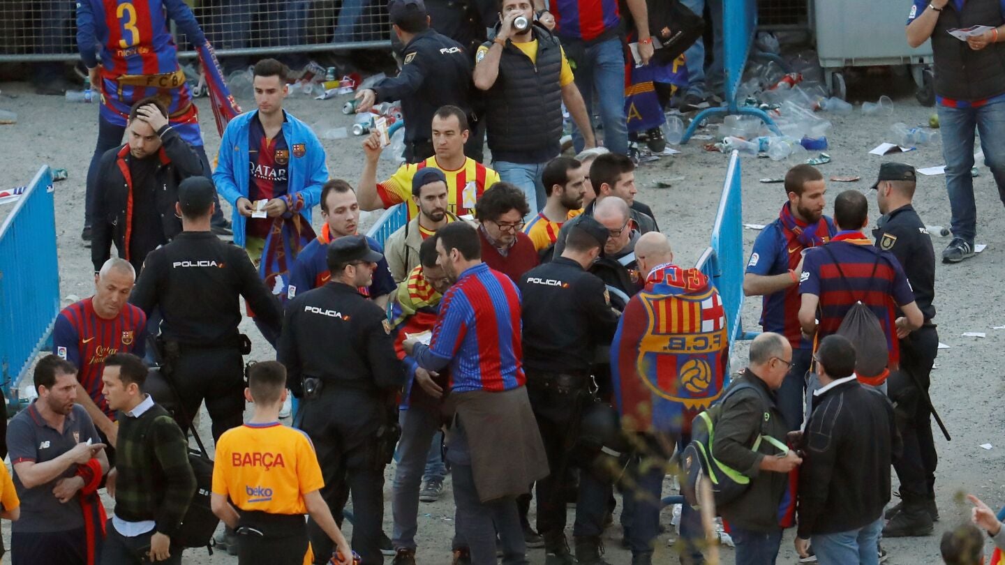 Agentes de la Polic&iacute;a Nacional junto a seguidores del Barcelona en los exteriores del Wanda Metropolitano