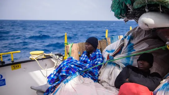 Inmigrantes descansan a bordo de un barco después de ser rescatados en el Mediterráneo Inmigrantes descansan a bordo de un barco después de ser rescatados en el Mediterráneo