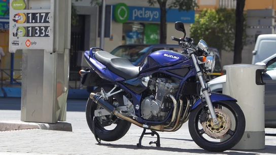 Una motocicleta estacionada en una gasolinera. Una motocicleta estacionada en una gasolinera.