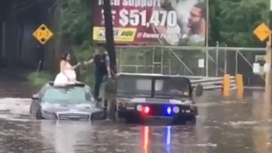 La novia escapa de la inundación con el vestido de novia puesto