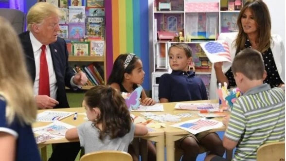 Trump ayuda a unos niños a colorear al bandera de EEUU