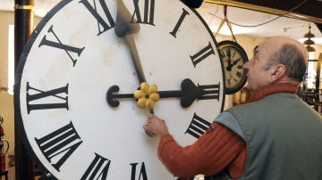 Peter Leonardy examina un reloj fabricado alrededor del año 1900 por la compañía Benedikt Schneider