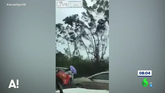 Dos mujeres luchan contra el viento para cruzar una calle en Filipinas Dos mujeres luchan contra el viento para cruzar una calle en Filipinas