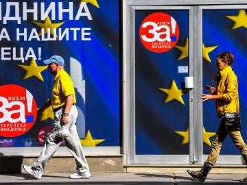 Transeúntes caminan frente a la oficina de la coalición que apoya el próximo referéndum en Skopje Transeúntes caminan frente a la oficina de la coalición que apoya el próximo referéndum en Skopje