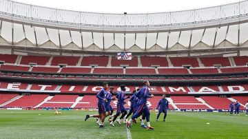 Los jugadores del Atlético se ejercitan sobre el césped del Wanda Metropolitano