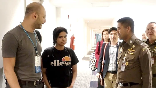 La joven saudí conversando con un jefe de la policía tailandesa La joven saudí conversando con un jefe de la policía tailandesa
