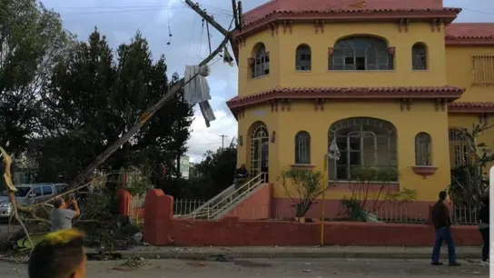 Un poste eléctrico caído sobre la fachada de un edificio en La Habana, Cuba. Un poste eléctrico caído sobre la fachada de un edificio en La Habana, Cuba.