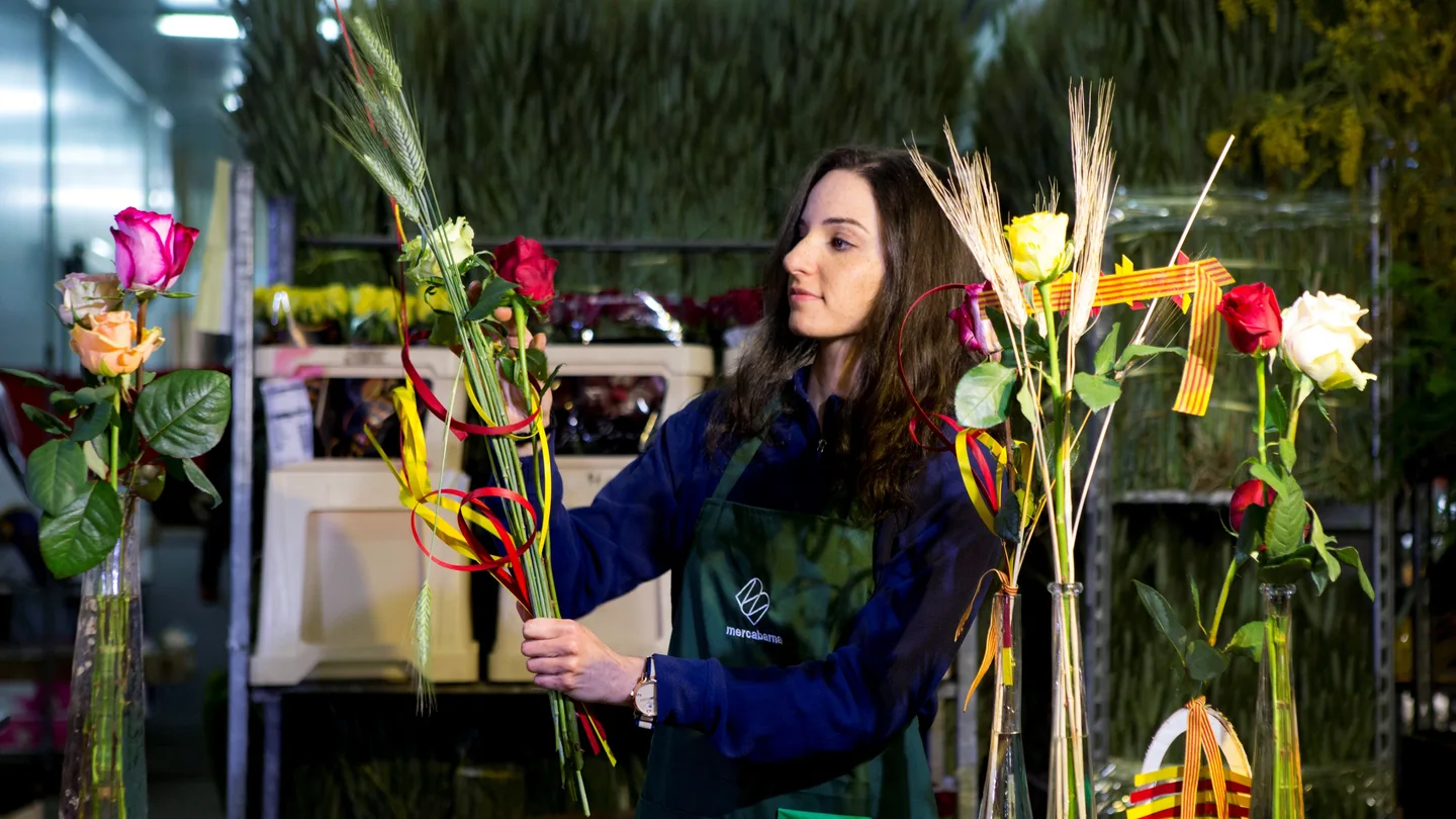 Una joven prepara rosas en el mercado mayorista de la flor de Mercabarna Una joven prepara rosas en el mercado mayorista de la flor de Mercabarna
