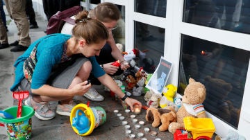 Manifestantes ponen velas durante una protesta por la muerte del niño