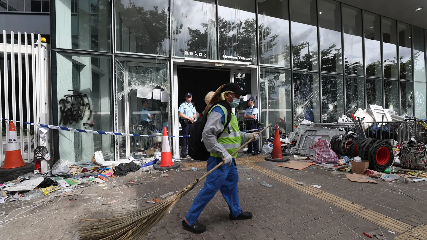 Funcionarios limpian los alrededores del Consejo Legislativo después de que manifestantes irrumpieran en el edificio, en Hong Kong Funcionarios limpian los alrededores del Consejo Legislativo después de que manifestantes irrumpieran en el edificio, en Hong Kong