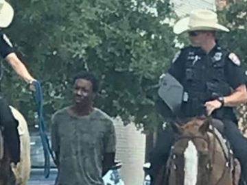 La imagen que ha desatado la polémica en Estados Unidos: dos policías transportan a un hombre negro atado con una cuerda. La imagen que ha desatado la polémica en Estados Unidos: dos policías transportan a un hombre negro atado con una cuerda.