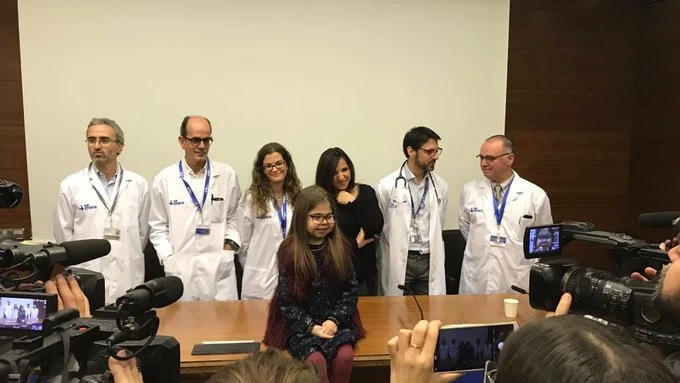 Íria posa con el equipo médico que la trató en el Hospital Vall d'Hebron