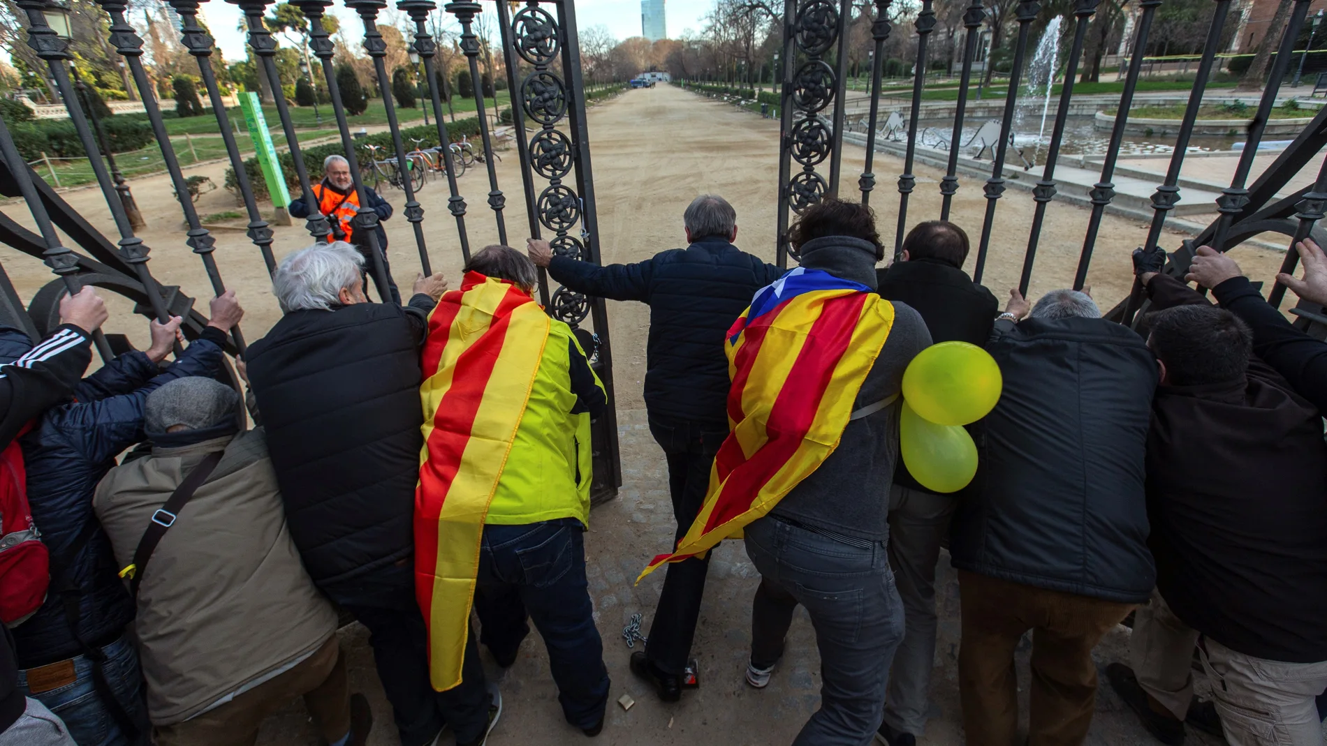 Los manifestantes abren la verja que rodea el Parlament en el Parc de la Ciutadella
