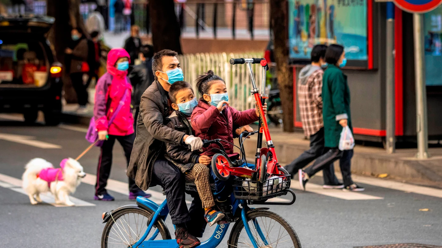 Un hombre con sus hijos en China Un hombre con sus hijos en China