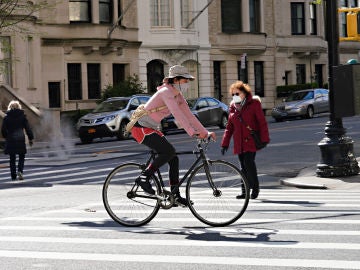 Una ciudadana monta en bicicleta por las calles de Nueva York