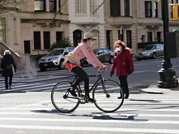 Una ciudadana monta en bicicleta por las calles de Nueva York Una ciudadana monta en bicicleta por las calles de Nueva York
