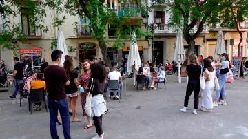 Fase 2 y fase 3 desescalada: Varios jóvenes hacen cola para sentarse en una de las terrazas de la plaza de la Vila del barrio de Gracia de Barcelona